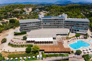 Aerial view of the beach hotel Aks Hinitsa Bay in Chinitsa, Greece, with swimming pool and solar plant on the roof
