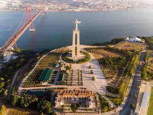 Aerial view of the Cristo rei monument with ponte 25 de abril bridge in Almada Lisbon