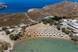 Aerial view of the Monastiri beach, with sunbeds and parasols on Paros, Greece