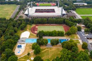 Aerial view of the outdoor pool "Stadionbad", in front of a sports field with running track and football stadium, near Cologne sports college in Germany