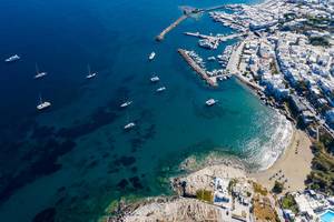 Aerial view of the village Naoussa on the Cyclades island Paros, Greece, with harbour and old Venetian castle ruin, in the bay Ormos Naousia
