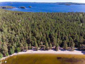 Aerial view shows different water colours and the island Kelvenne with its beach and bays at Lake Päijänne