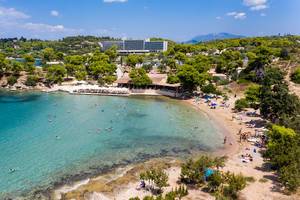 Aerial view shows holidaymaker at Hinitsa beach and restaurant, at the coast of Argolic Gulf in Ermionida, Greece