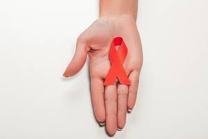 Aids red ribbon on woman