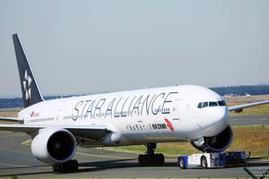 Air China Star Alliance plane being towed in Frankfurt Airport
