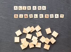 Alibaba Singlesday with wooden tiles on a black surface