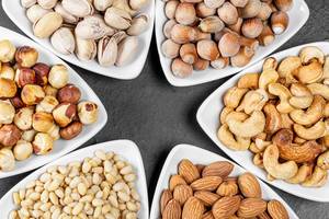 Almonds, hazelnuts, pine nuts, pistachios, cashews and filbert in triangular bowls (Flip 2020)