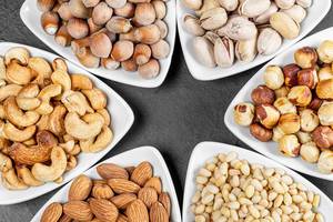 Almonds, hazelnuts, pine nuts, pistachios, cashews and filbert in triangular bowls
