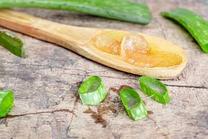 Aloe pulp in a wooden spoon and fresh leaves. The concept of Spa, medicinal plant