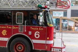 American Fireman in a red departement truck with ladder in Chicago