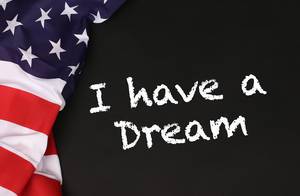 American flag with the text I have a Dream against a blackboard background