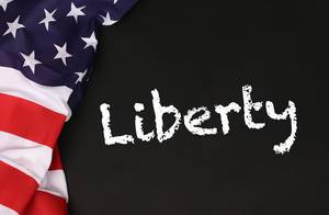 American flag with the text Liberty against a blackboard background.jpg