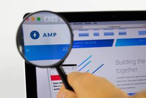 AMP logo on a computer screen with a magnifying glass