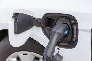 An electric car by Ford is being tanked with a TankE device at the E-Cologne trade show for electric mobility