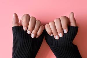 An unrecognizable female showing her hands with beautiful nail manicure