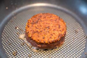 Angebratener fleischloser Burger von Beyond Meat, in einer Pfanne, als glutenfreies Mittagessen für eine vegan Ernährung