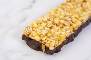 Antioxidant Cereal Bar with Orange on the kitchen table