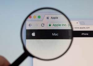 Apple logo on a computer screen with a magnifying glass
