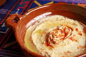 Arabic Hummus dip with hot spices in a ceramic bowl