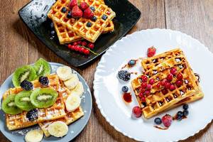Assortment beautiful serve waffles with berries, fruits and syrups (Flip 2019)