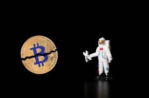 Astronaut with with broken Bitcoin