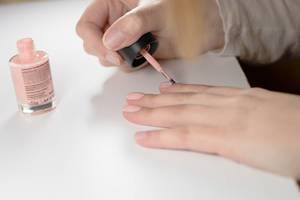Aufnahme einer Frau die sich die Nägel lackiert