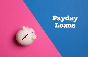 Auschfrift "Payday Loans" - Zahltagsdarlehen - neben einem rosa Sparschwein, auf blau-pinke Hintergrund