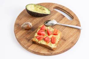 Avocado on the bread with sliced tomato
