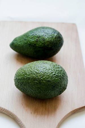 Avocados on wooden board