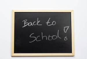 Back to school written on a black chalkboard