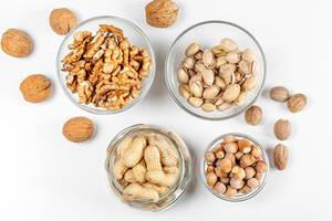 Background with different types of nuts in the skin and without