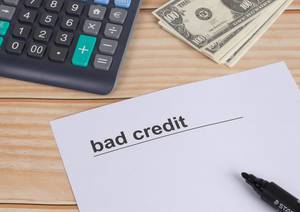 Bad credit text with calculator and money