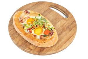 Baked Bread with Eggs and Onions on the wooden board