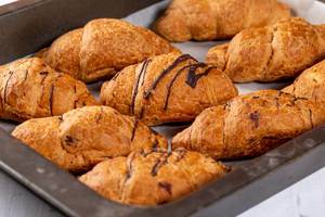 Baked croissants on a baking sheet