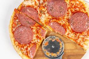 Baked Pizza with Sausage and round cutting knife
