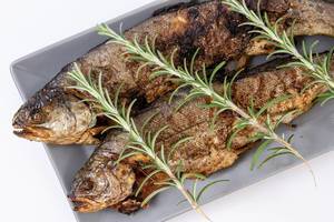 Baked Trout fish on the plate with Rosemary (Flip 2019)