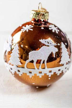 Ball for a Christmas tree with an ornament of trees and a deer