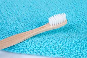 Bamboo toothbrush on towel (Flip 2019)
