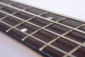 Bass Guitar Neck with Strings with blurred background (Flip 2019)