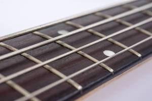 Bass Guitar Neck with Strings with blurred background