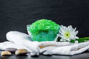 Bath salts and a clean white towel - the concept of a relaxing Spa