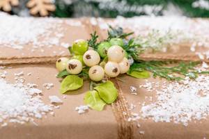 Beautiful decorated gift on snow background. The concept of preparing for the Christmas holidays