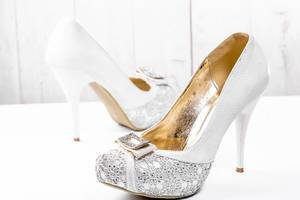 Beautiful wedding shoes with heels on white background