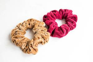 Beige and red scrunchies on white background