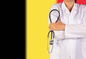 Belgisches Gesundheitssystem symbolisiert durch die Nationalflagge und eine Ärztin mit Stethoskop in der Hand
