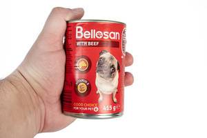 Bellosan Dog Food can in the hand with copy space above white background