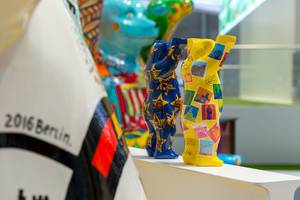 Berlin souvenirs: colorful Buddy Bears from behind with stamp motive