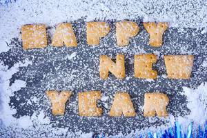 Biscuit letters, snowing on Happy New Year message