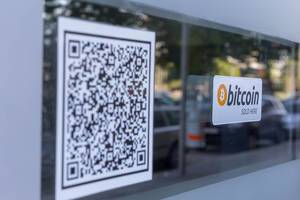 Bitcoin sold here and barcode stickers on a window