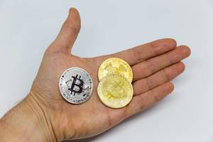 Bitcoins presented in a hand